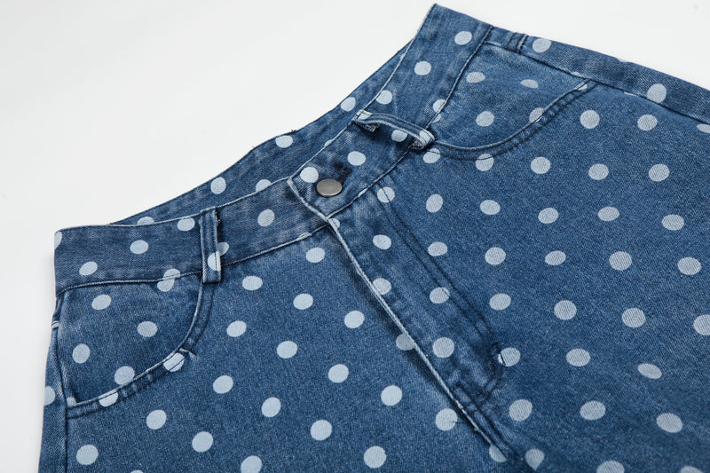 Close-up of front waistband and pocket on blue polka dot denim jeans