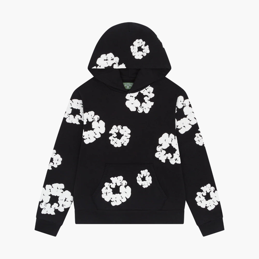 The Black “Cotton Wreath” Denim Tears Hoodie features a front pocket and an all-over white floral ring print, perfect for fans of unique streetwear styles.