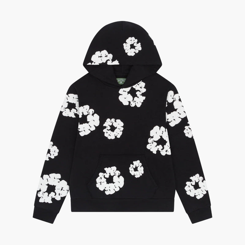 The Black “Cotton Wreath” Denim Tears Hoodie features a front pocket and an all-over white floral ring print, perfect for fans of unique streetwear styles.