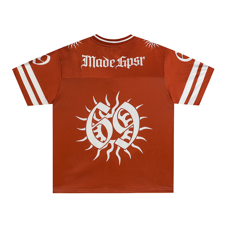 Rust red mesh football jersey with white striped sleeves, solar emblem graphic, and gothic MadeGspr lettering