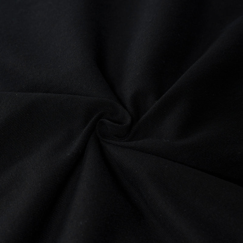 Black washed cotton tee fabric with soft folds and a distressed streetwear look