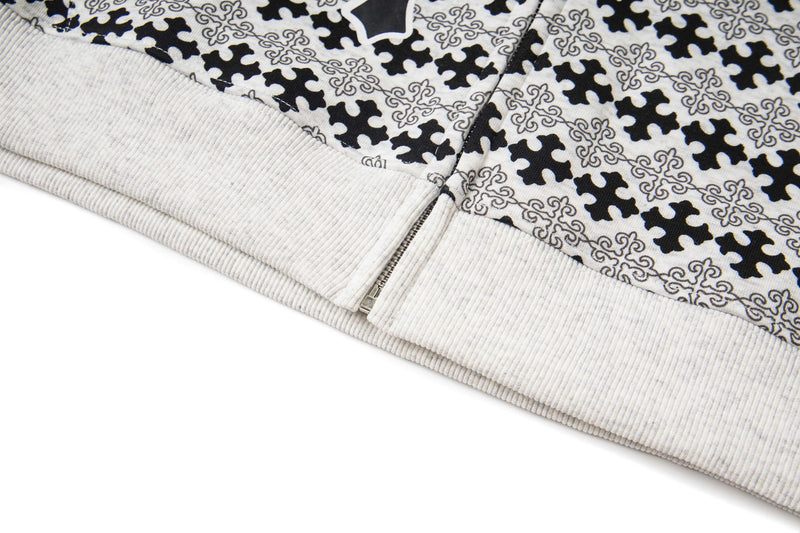 Bottom hem and zipper close-up on black and white hoodie