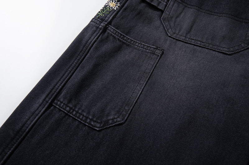 Close-up of back pocket stitching on washed black carpenter jeans