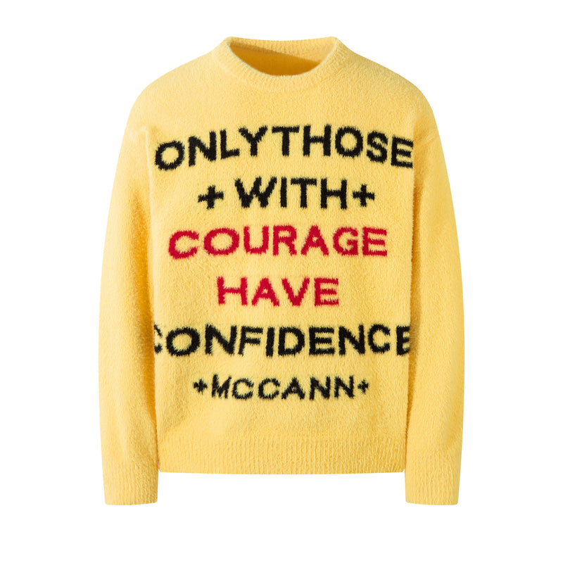 Yellow fuzzy knit crewneck sweater with bold slogan text on the front