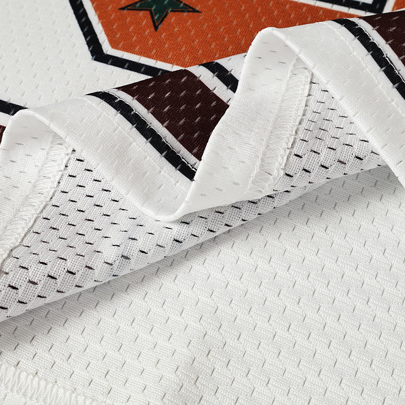 Close-up of a white mesh varsity jersey with burgundy and black star graphic detailing
