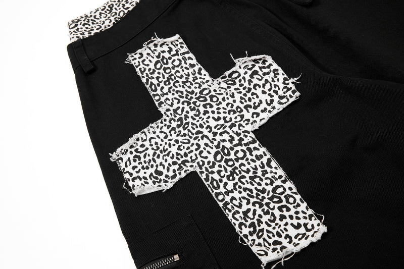 Frayed leopard-print cross patch on black cargo pants leg