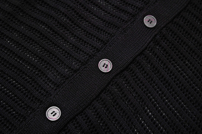 Black open-knit button-up shirt with three visible buttons and textured star-pattern knit detail