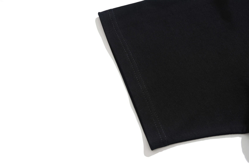 Black graphic tee sleeve with visible hem stitching on a clean white background
