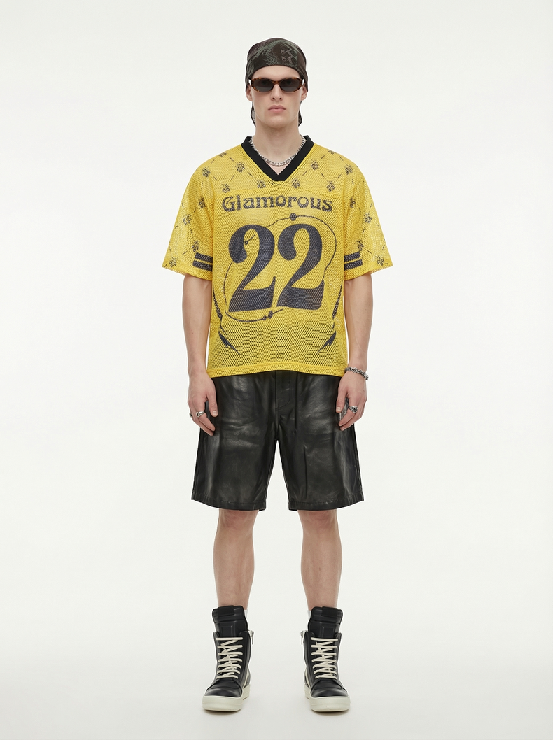 Yellow mesh jersey T-shirt with Glamorous 22 print, styled on a model with black shorts and sneakers