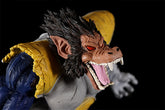 The Seakoff Great Ape Vegeta Collectible Figure from Dragon Ball Z is a 36cm premium action figure with a monkey-like face, sharp fangs, red eyes, pointed ears, dark spiky hair, and a blue and yellow outfit. Its mouth is open in an aggressive expression.