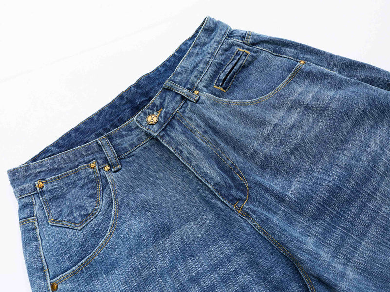 Angled top view of blue denim shorts showing the waistband, front pocket, and pocket trim