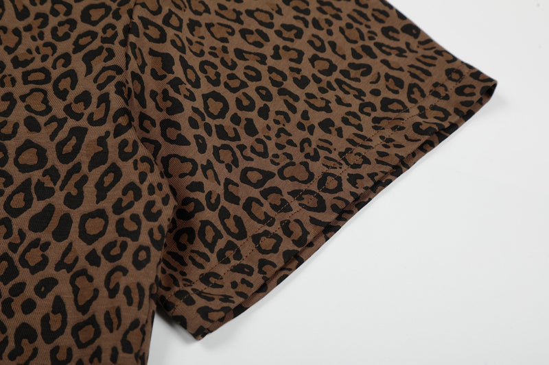 Close-up of a brown leopard print polo tee sleeve with black pattern and stitched hem on a white background