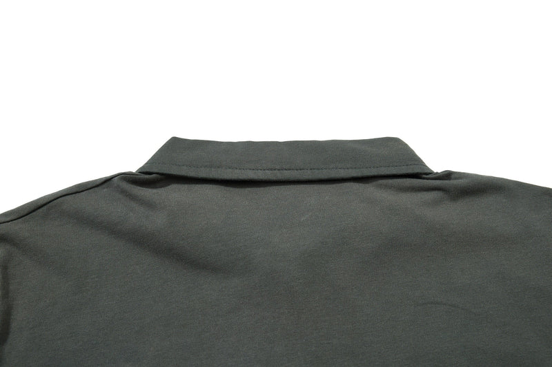 Close-up of an olive green vintage polo tee collar and upper chest in soft cotton fabric on a white background