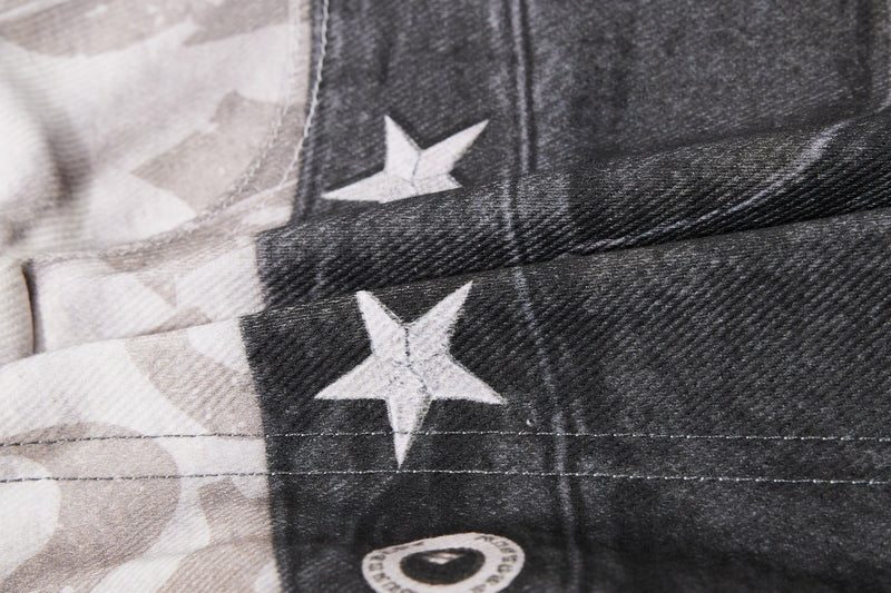 Close-up of layered seam with star print across light and black denim panels