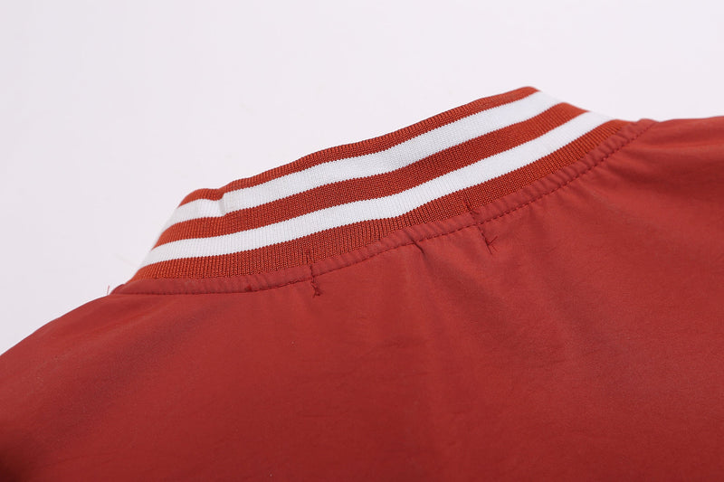 Close-up of red sweatshirt V-neck collar with white striped rib knit trim