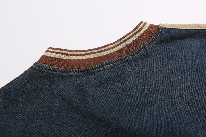 Close-up of striped ribbed crew neckline on dark blue denim sweatshirt