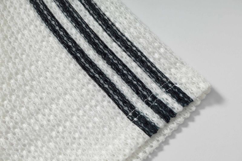 White textured knit polo shirt with black vertical stripes and ribbed cuff detail, featuring a sporty rugby-inspired design