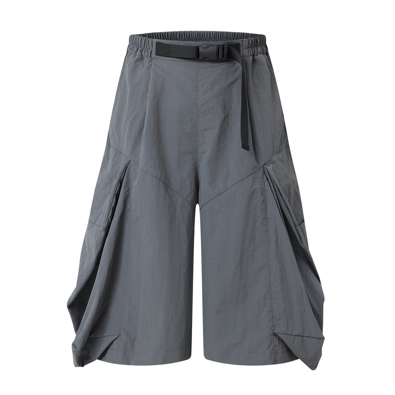 Gray wide-leg shorts with elastic waistband, buckle belt, and draped panels, front view