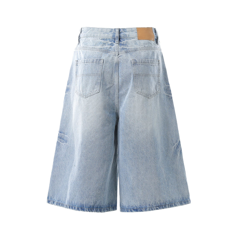 Light wash denim shorts back view with patch pockets and tan waistband label