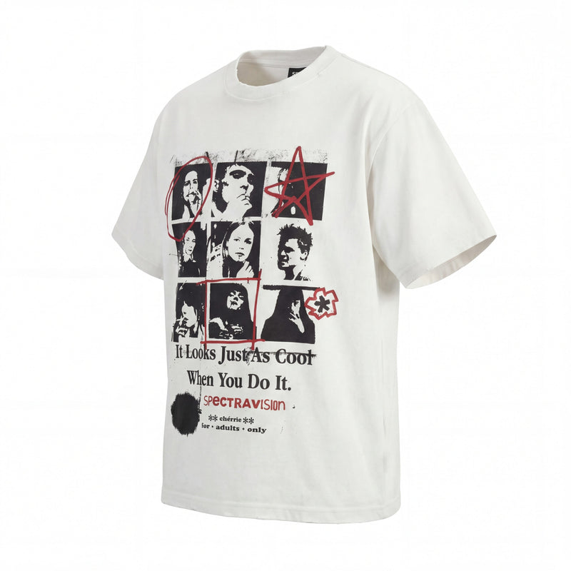 White oversized graphic tee with black collage portraits, red scribble accents, and vintage grunge text print