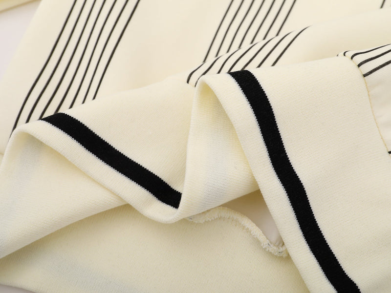 Close-up of cream sleeve cuff and pinstriped fabric texture