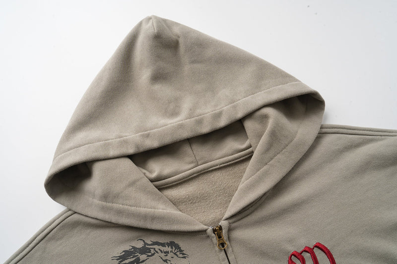 Close-up of taupe hoodie hood and gold zipper at the front neckline