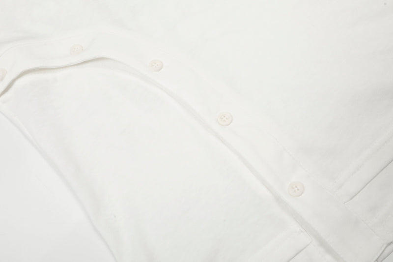 Close-up of white long sleeve tee fabric with side buttons and stitching