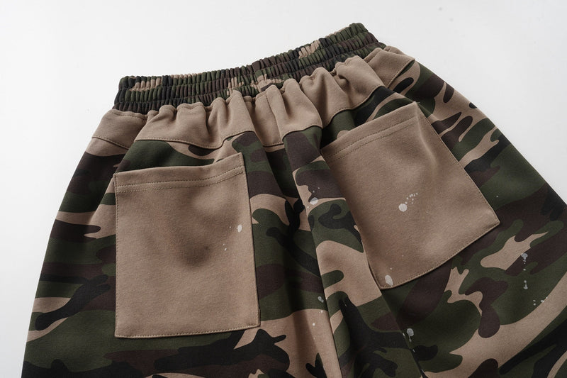 Back view close-up of two patch pockets on camo baggy shorts