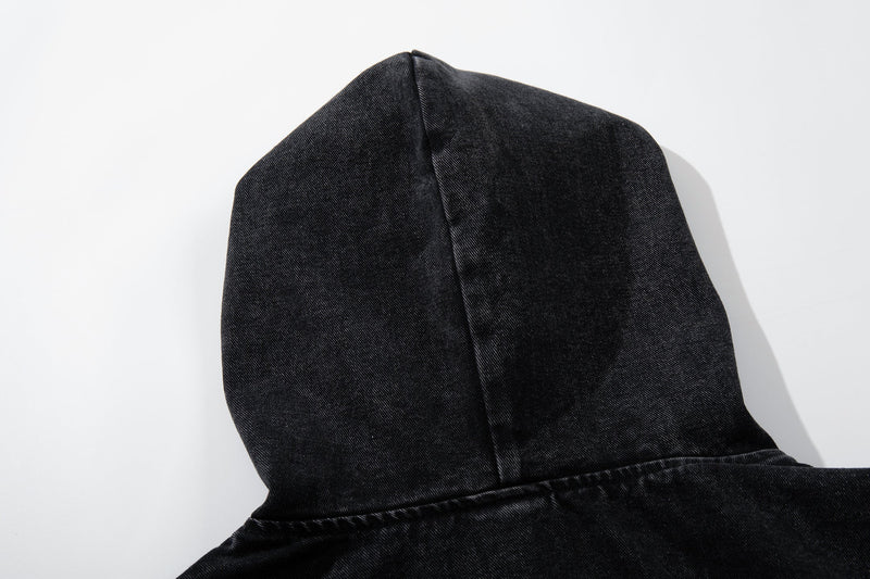Close-up side view of the black denim hood with washed texture