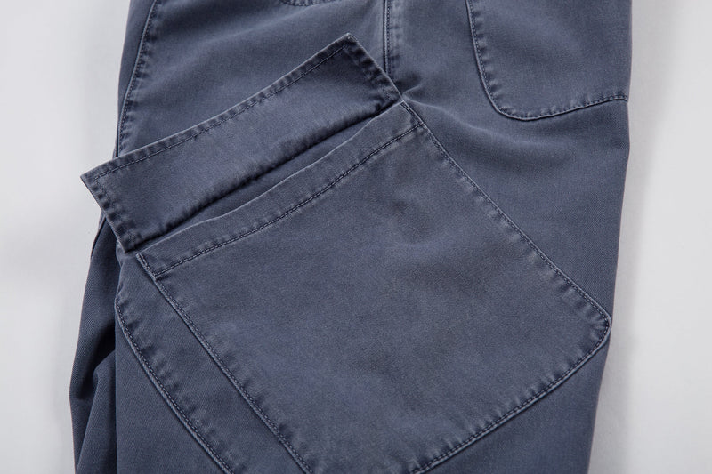 Close-up of angled side cargo pocket on blue denim pants