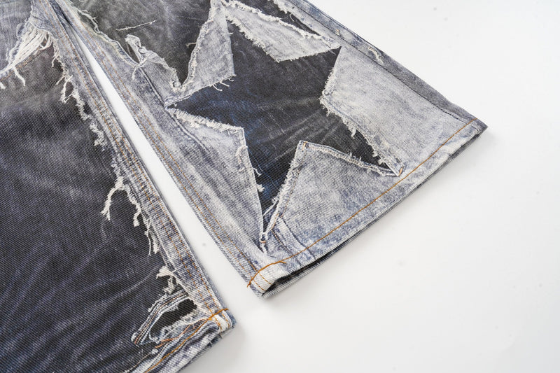 Close-up of the lower leg on patchwork jeans with star cutout and frayed edges