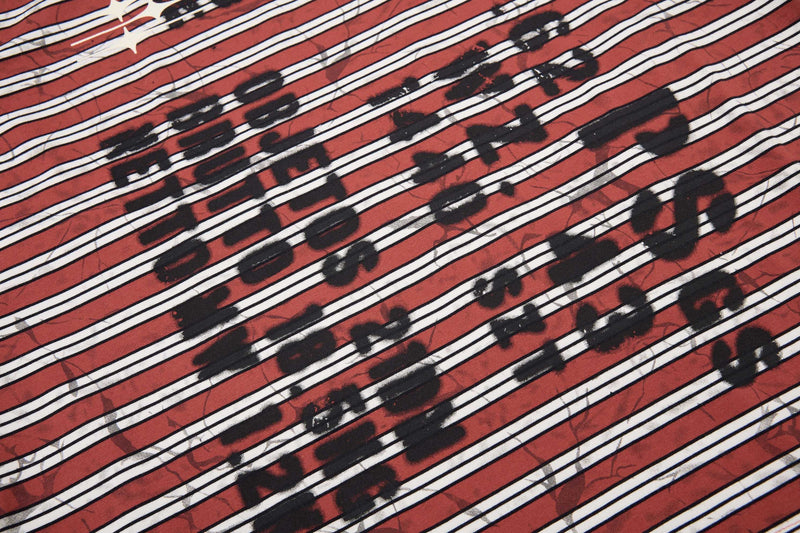 Red streetwear T-shirt fabric with bold white stripes and black graffiti-style lettering print