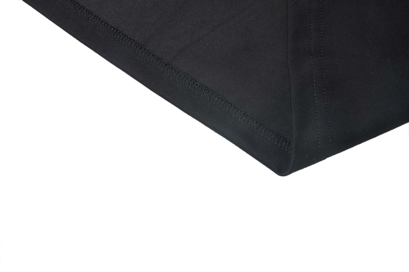 Close-up of black T-shirt hem with visible stitching on a clean white background