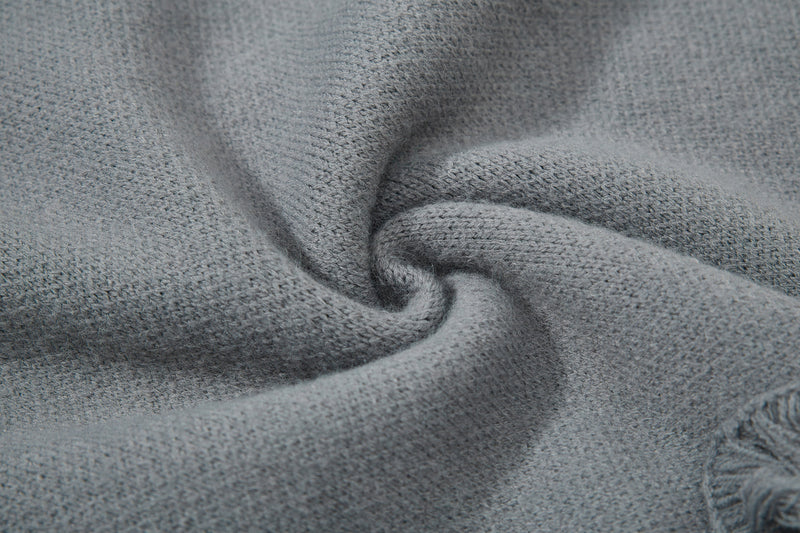Gray knit sweater close-up of soft knit fabric folds