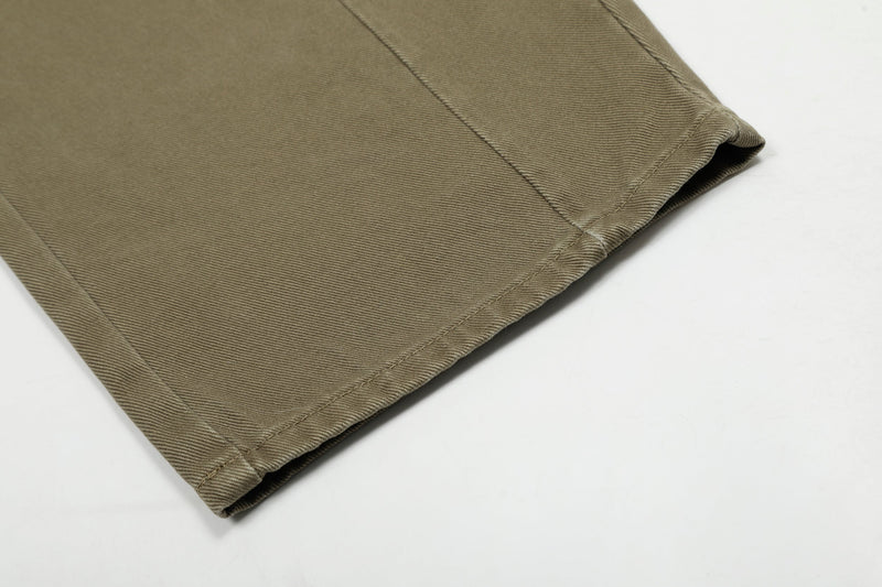 Close-up of olive cargo jeans hem with clean stitched cuff