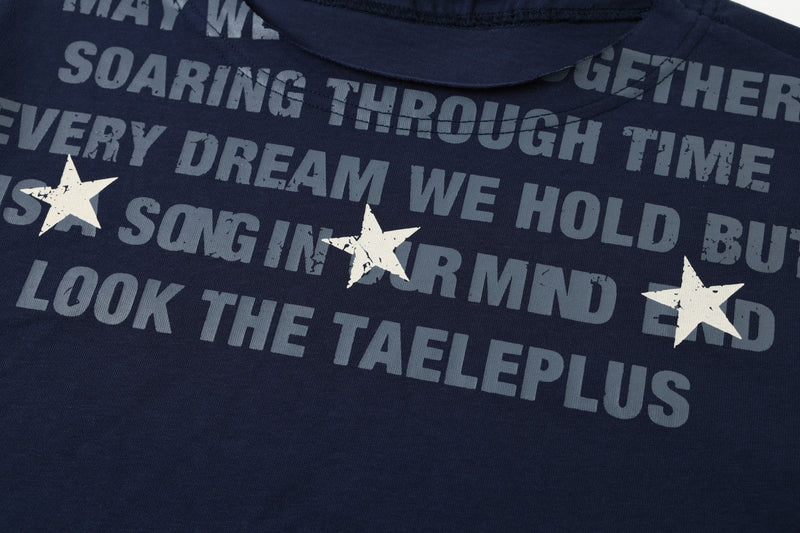 Chest close-up showing distressed gray slogan print and white star graphics on navy fabric