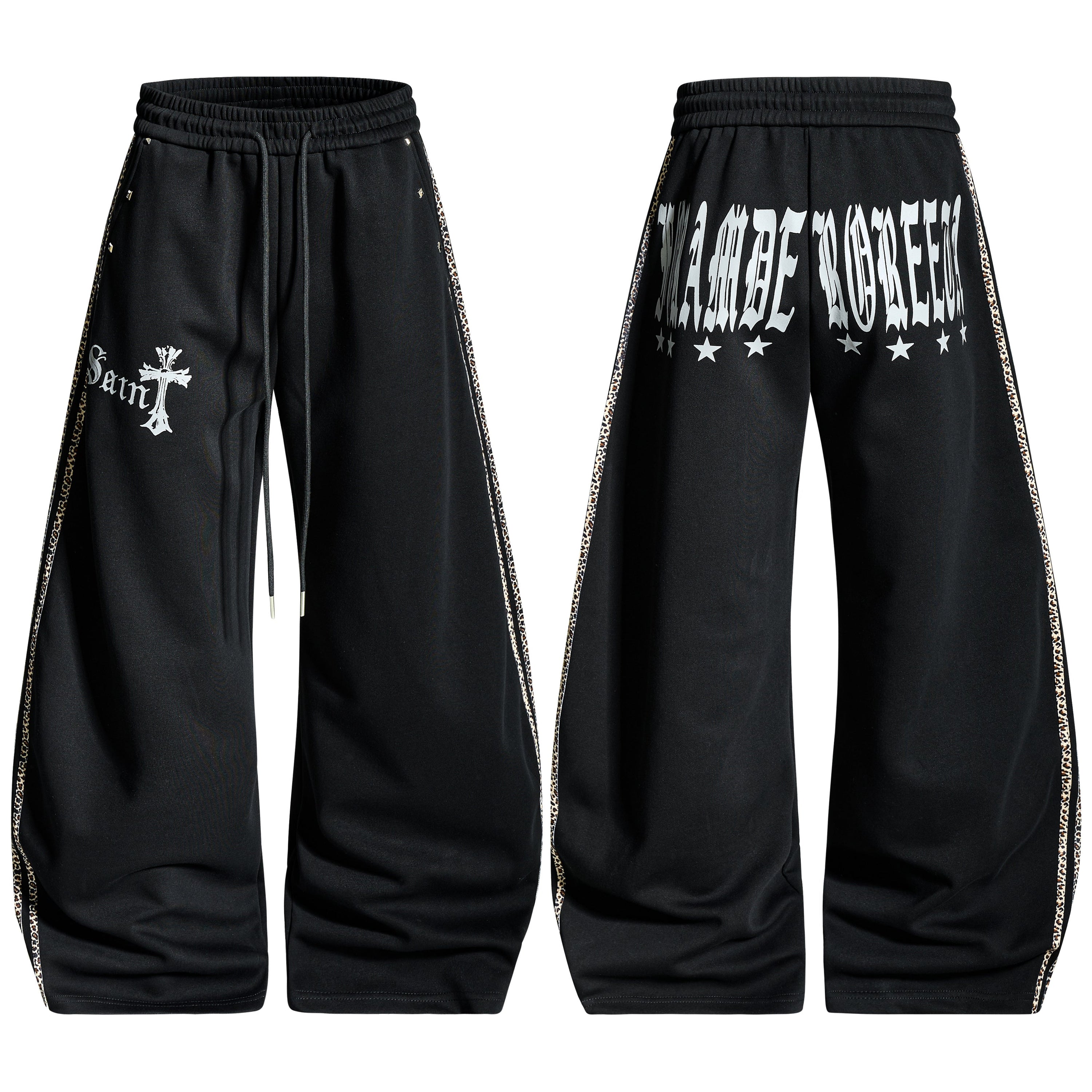 Black wide-leg gothic cross track pants with leopard side panels and old-English script graphic, front and back view