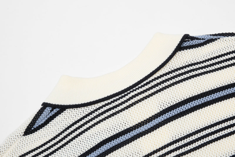 Cream knit polo shirt with black and light blue retro stripes and a ribbed collar on a white background