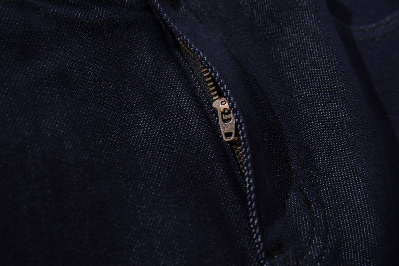 Close-up of denim zipper fly with metal zipper pull