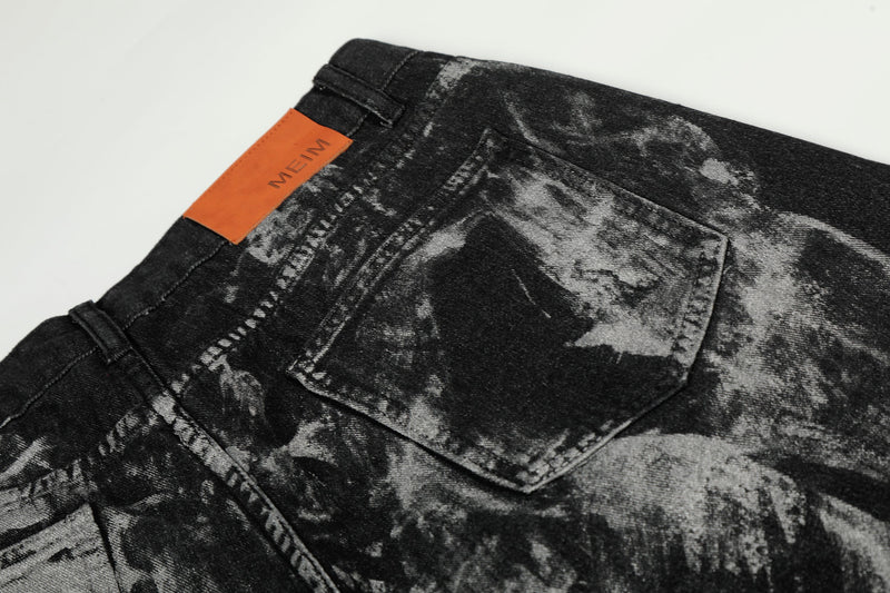Close-up of back pocket and waistband on black painted denim with orange MEIM patch