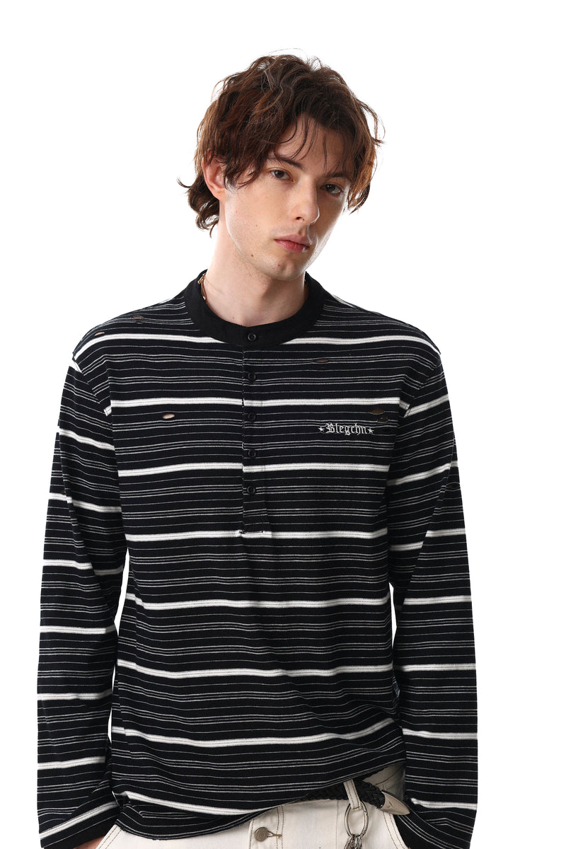 Close front view of black striped Henley tee with distressed holes and button placket