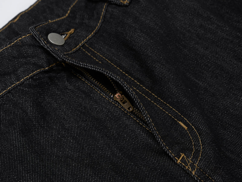 Close-up of zipper fly and top stitching on dark wash carpenter denim