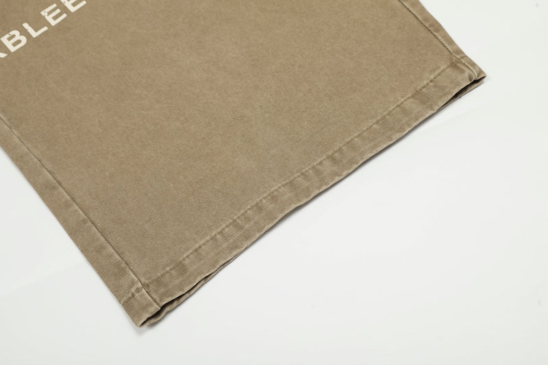 Close-up of lower hem on khaki wide-leg pants