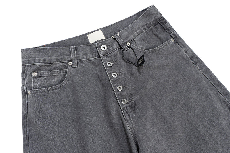 Front top of washed grey denim pants with button-fly closure, coin pocket and belt loops