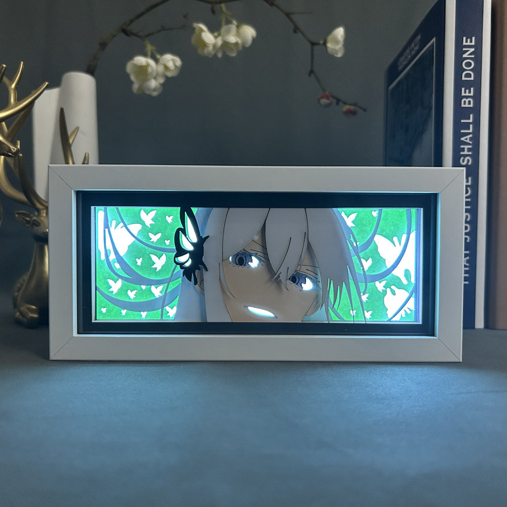 The Re:Zero Echidna 3D LED Lamp showcases the character with long white hair and a neutral expression against a green background with white birds, framed in a rectangular display with dynamic lighting on a surface decorated with an antler and plant.