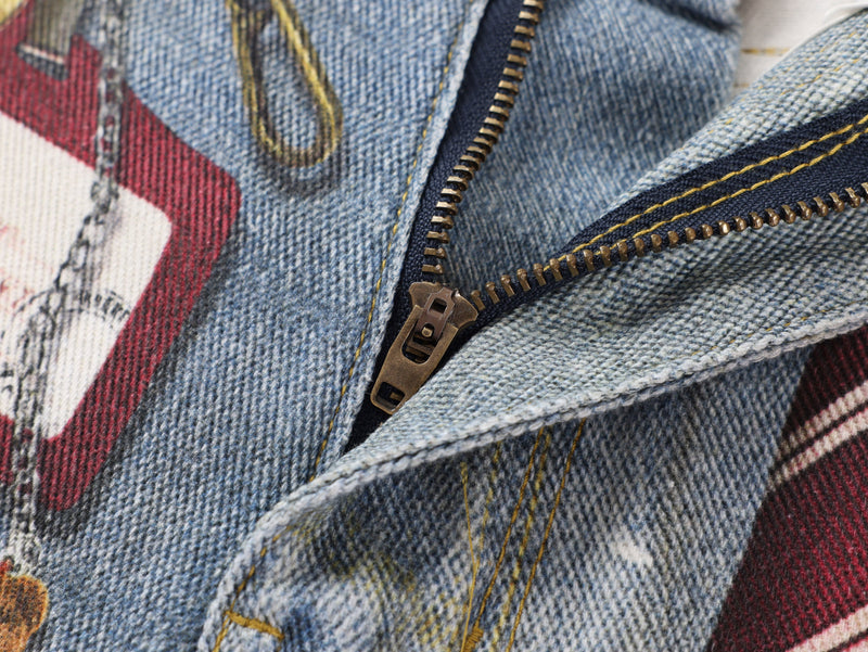 Close-up of zipper fly and denim front seam with red striped fabric beneath