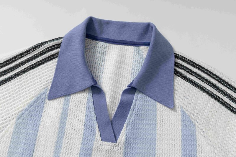 Close-up of a striped knit polo tee with a lavender collar and V-neck detail in white, blue, and black tones