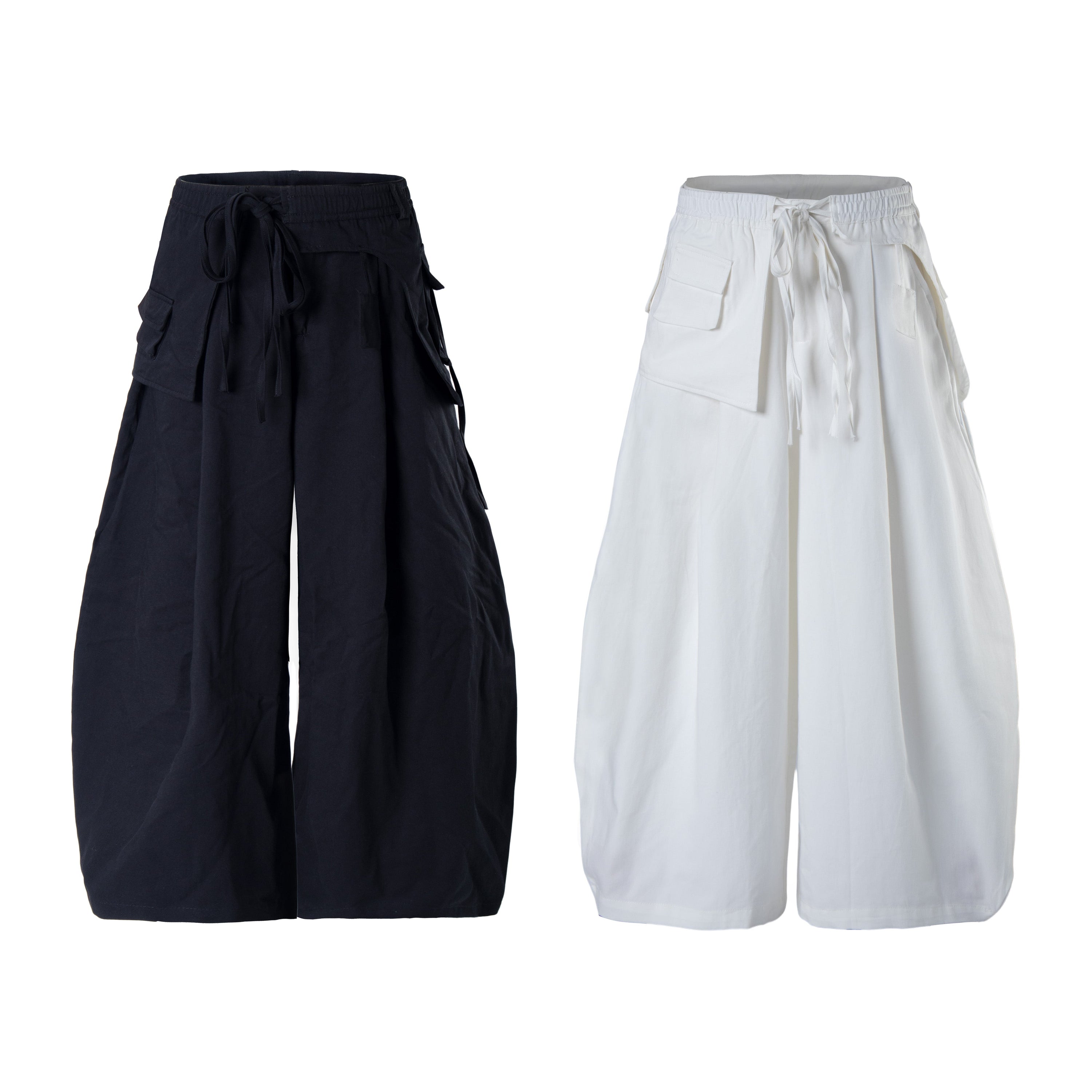 Navy and white minimalist balloon cargo pants with oversized flap pockets and adjustable drawstring waist, shown side by side