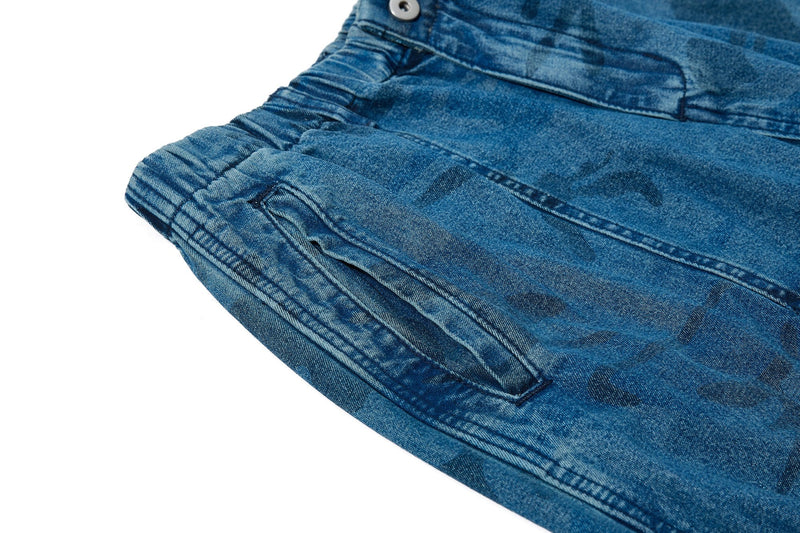 Close-up of side pocket and seam detail on washed blue camo baggy jeans
