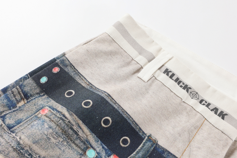 Angled close-up of the upper front waist with printed belt graphic and KLICK CLAK text